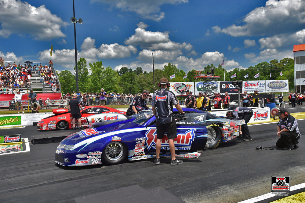 pro stock cars staging at an nhra race