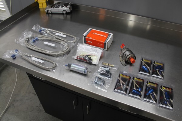 fuel system parts laid out on a workbench