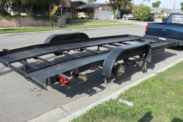 a car trailer with its dually wheels removed