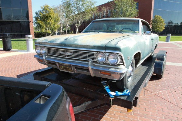 project car chevy chevelle tied down to a car trailer