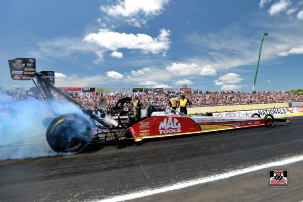 nhra top fuel dragster doing a burnout at the track