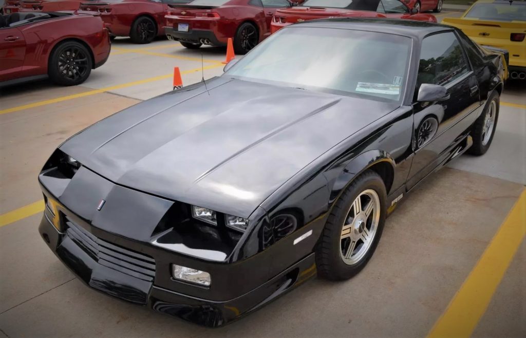 black third generation chevy camaro rs at a car show