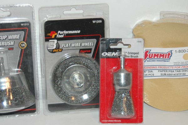 assortment of sanding pads and wire brushes