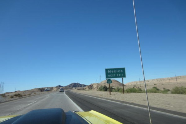 view of a Mexico highway sign from the seat of a vintage dodge demon