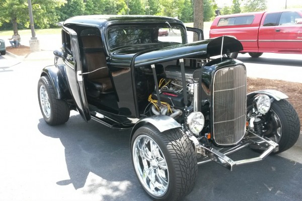 black hotrod ford coupe with suicide doors opened