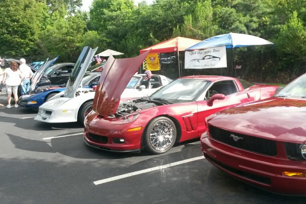 row of corvettes at a car show