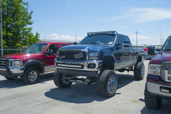 lifted pickup trucks at a car show