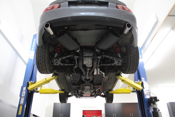 underside carriage view of an ls swapped mazda miata on a lift