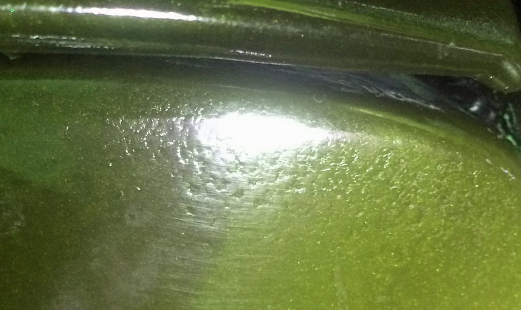 example of orange peel happening in a green automotive paint job