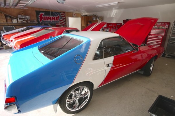 group of three am amx muscle cars in a garage