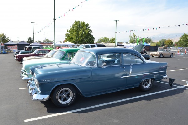 1955 blue chevy coupe at a car show
