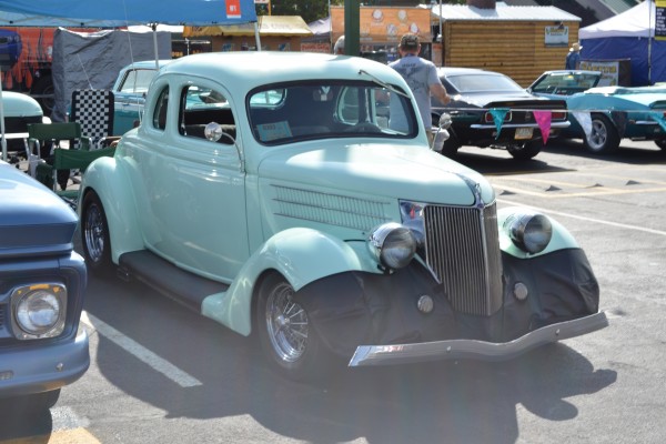 vintage blue hotrod at a car show