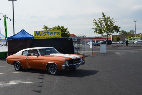 copper and white chevelle ss fastback coupe entering car show