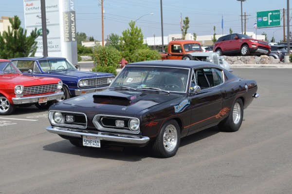 440ci plymouth barracuda muscle car entering parking lot of a car show