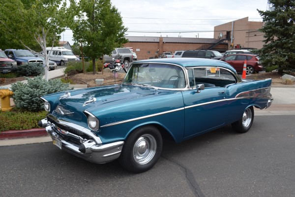 1957 chevy coup parked on street of a small town