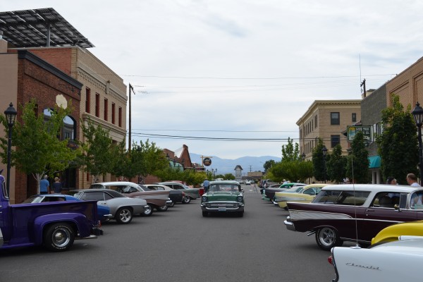 classic cars parked on street of a small town
