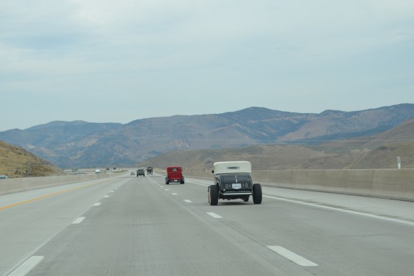 a pair of hot rods on desert highway
