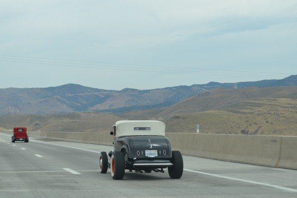 vintage hot rod roadster on desert highway