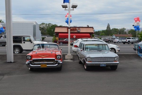 a classic 1957 chevy bel air and chevy II nova wagon in a parking lot