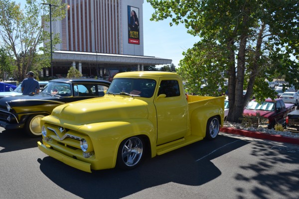yellow custom ford truck at car show parking lot