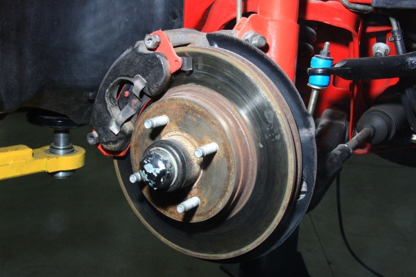 factory brake caliper and rotor on a ford mustang