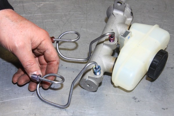 a vehicle master cylinder on workbench