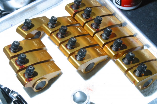 rocker arms lined up on a workbench