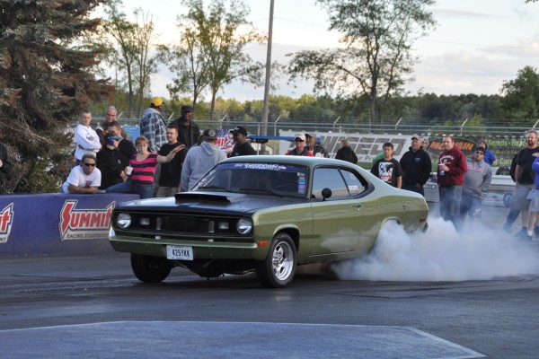 plymouth duster doing a burnout at dragstrip