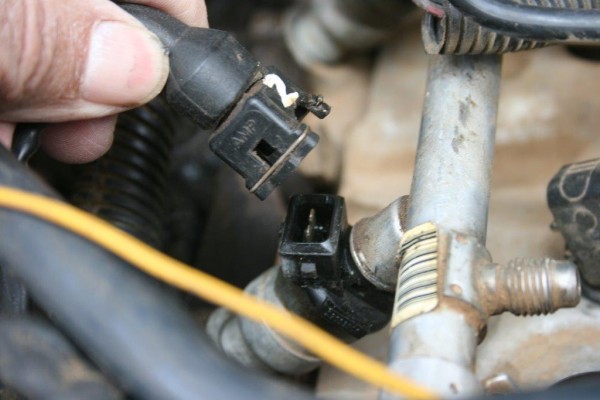 unplugging a wiring harness from a fuel injector