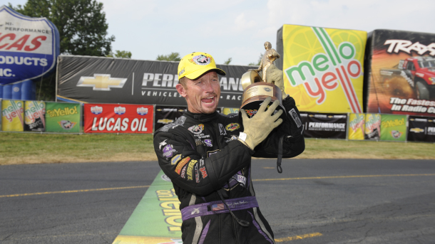 jack beckman holding wally trophy at NHRA event