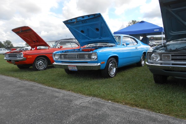 row of vintage mopar musclecars at a show