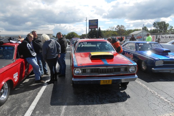 classic mopar muscle cars in staging lanes at dragstrip