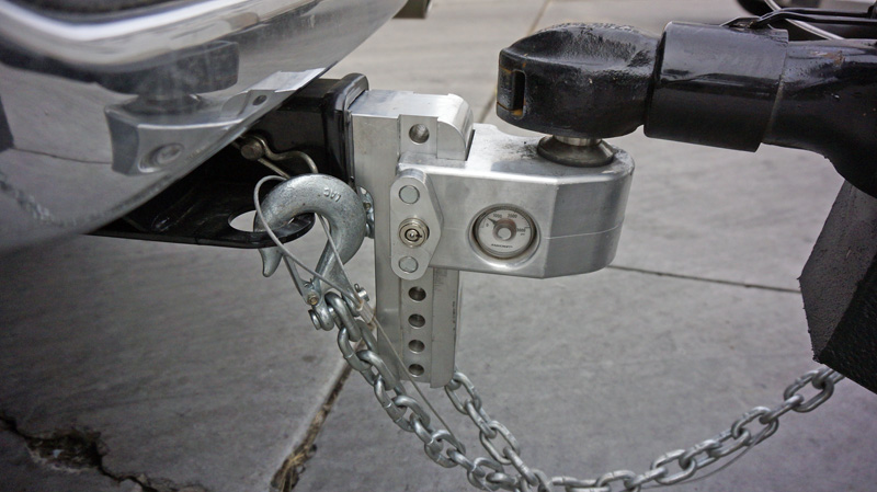 a close up of a trailer hitch bumper with safety chains