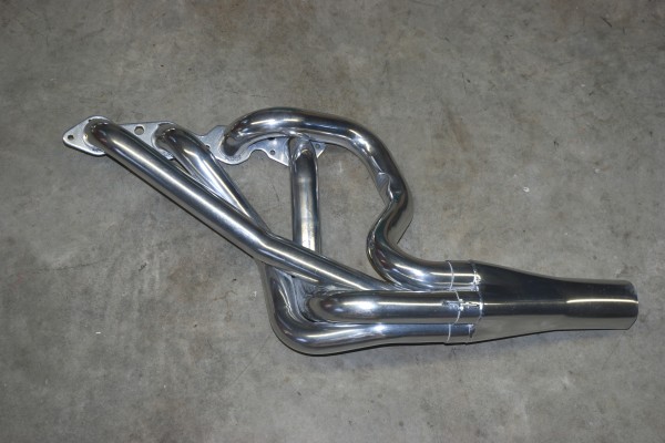 an exhaust header sitting on garage floor