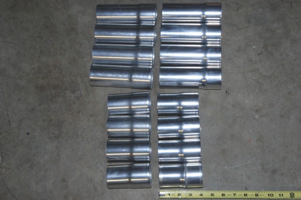 collection of header exhaust pipe reducers on shop floor