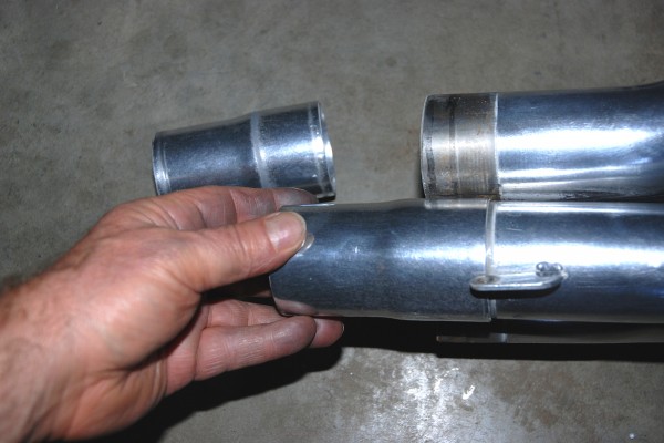 man holding header collector tubing