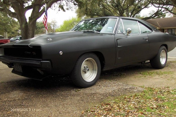 black 1968 dodge charger restomod in driveway