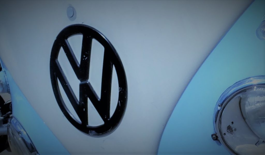 stylized vw emblem on the front of a VW Type 2 transporter bus