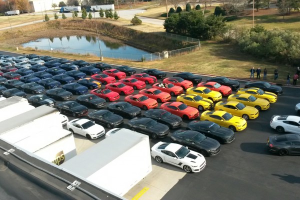 rows of s550 ford mustangs at a car club meetup at summit racing store