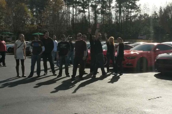 group of people at a ford mustang car meet