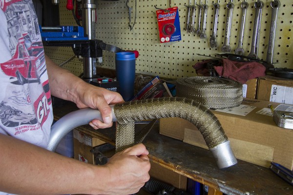 man wrapping a motorcycle exhaust primary