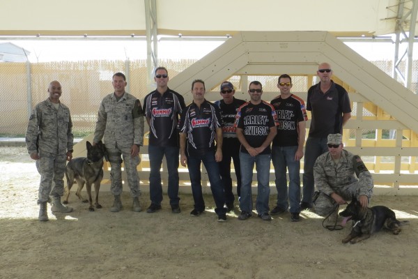 NHRA drivers greet troops and canine unit at remote military base