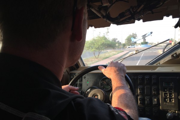 nhra driver behind the wheel of a military vehicle