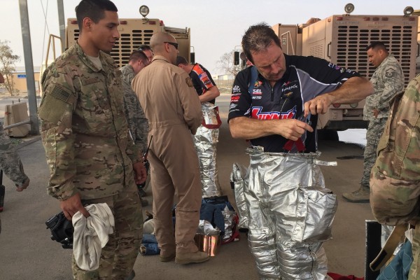 nhra drivers wearing fire suits during tour of a military base