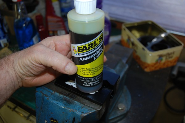 man holding a bottle of Earl's hose assembly lube