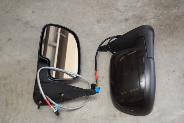 a pair of chevy Silverado side mirrors on a shop floor