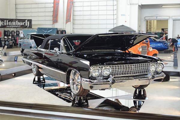 custom chevy impala convertible on display at indoor car show