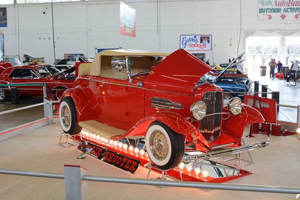 red ford hotrod coupe at indoor car show
