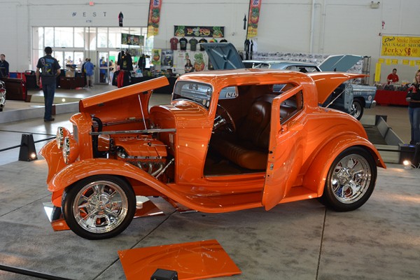 orange custom ford three window hot rod at indoor car show