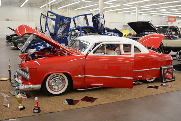 lowered coupe with lake pipes at indoor car show